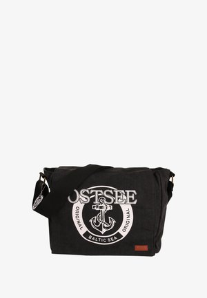 Black canvas messenger bag with a large white anchor graphic, adjustable strap, and leather accent tag. Features flap closure.
