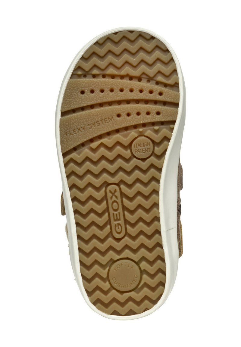 Soletta di scarpa in gomma marrone con un motivo a zigzag, bordo bianco e marchio in rilievo. Presenta fori di ventilazione e dettagli "Flexy System".