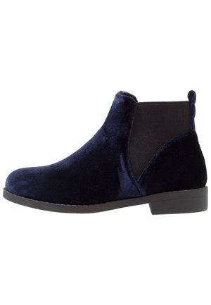 Navy blue velvet Chelsea ankle boot with black elastic side panels and a low black heel sole.