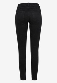 Jeans skinny negros de denim, con una cintura de altura media, cuatro bolsillos y una textura suave. Vista trasera que muestra un estilo ajustado.