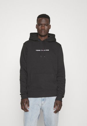 Sudadera negra de algodón con cordones, bolsillo frontal tipo canguro y logo bordado "TOMMY JEANS" en rojo y blanco en el pecho.