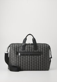 Black patterned bag with leather accents, featuring dual top handles, a removable shoulder strap, and a front zip pocket.