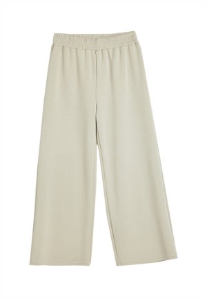 Pantalon large beige clair avec taille élastique, fabriqué en tissu doux, conçu pour le confort et la facilité de port.