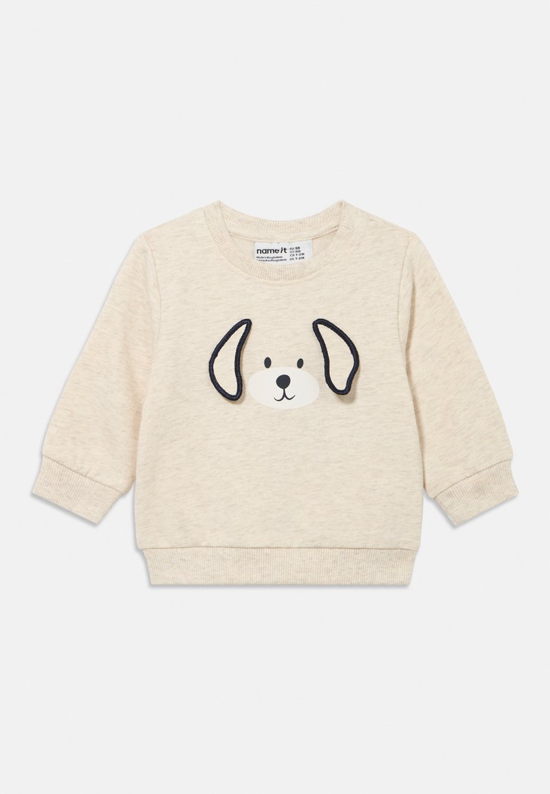 Felpa beige con motivo faccia di cane con accenti neri sulle orecchie, polsini a costine e scollo rotondo, realizzata in tessuto morbido.