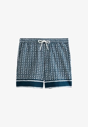 Shorts de bain bleu marine avec un motif géométrique blanc, taille élastique, fermeture à cordon de serrage et bord contrastant bleu foncé au bas.