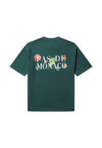 Mørkegrønn bomull T-skjorte med korte ermer, med et blomsterdesign og "PAS DE MONACO"-tekst i hvitt. Klassisk rund hals.