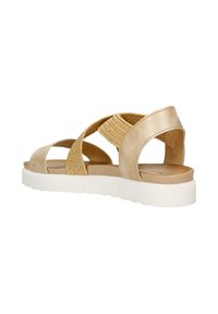 Sandali da donna beige con design a fasce decorate, morbida texture in pelle e una spessa suola bianca per un maggiore comfort.