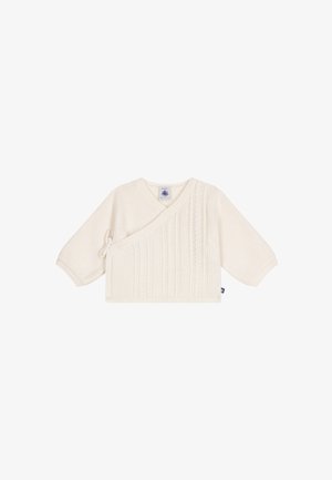 Pull bébé tricoté couleur crème avec devant croisé, manches longues, fermeture latérale à nouer et motif torsadé vertical sur le devant.