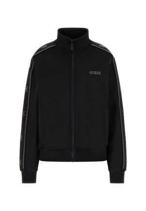 Zwarte zip-up jas gemaakt van gladde stof, met een hoge kraag, ribgebreide manchetten en een metalen logo met sierlijke accenten langs de mouwen.