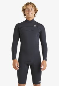 Traje de neopreno negro con mangas largas, diseño ajustado, textura suave, bolsillo con cremallera en el pecho y marcas en la pierna y la muñeca.