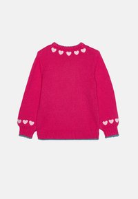 Pink knitted sweater with a round neckline, featuring white hearts along the back and sleeves, ribbed cuffs, and a teal accent at the hem.