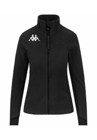 Giacca in pile nera con colletto alto, zip intera e logo bianco sul lato sinistro del petto. Presenta due tasche laterali e una texture morbida.