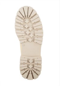 Gummisohle in Off-White mit einem geriffelten Muster. Verfügt über Traktionsnoppen und einen glatten zentralen Abschnitt. Größe angegeben als 40.