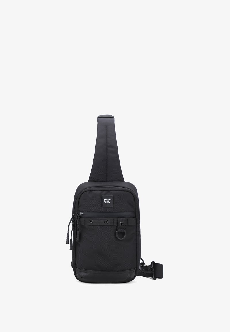 Borsa a tracolla nera realizzata in nylon resistente, di forma rettangolare, con scomparti con zip, tracolla regolabile e una finitura testurizzata.