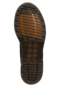 Černá gumená podešev boty s texturovaným vzorem, obsahující drážky a vystouplé tečky pro lepší trakci. Plochá, s hladkým okrajem a minimálním zdobením.