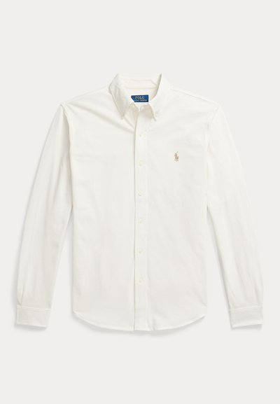 Valge pikakäeline nööbitav särk kraega ja Polo Ralph Laureni logo vasakul rinnal tikitud.