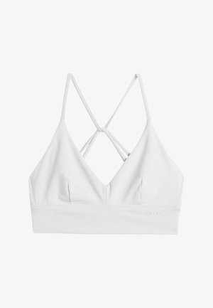 Bralette blanco con un escote en V profundo, tirantes entrecruzados en la parte posterior y una textura suave. Incluye un sutil detalle del logo en la banda.