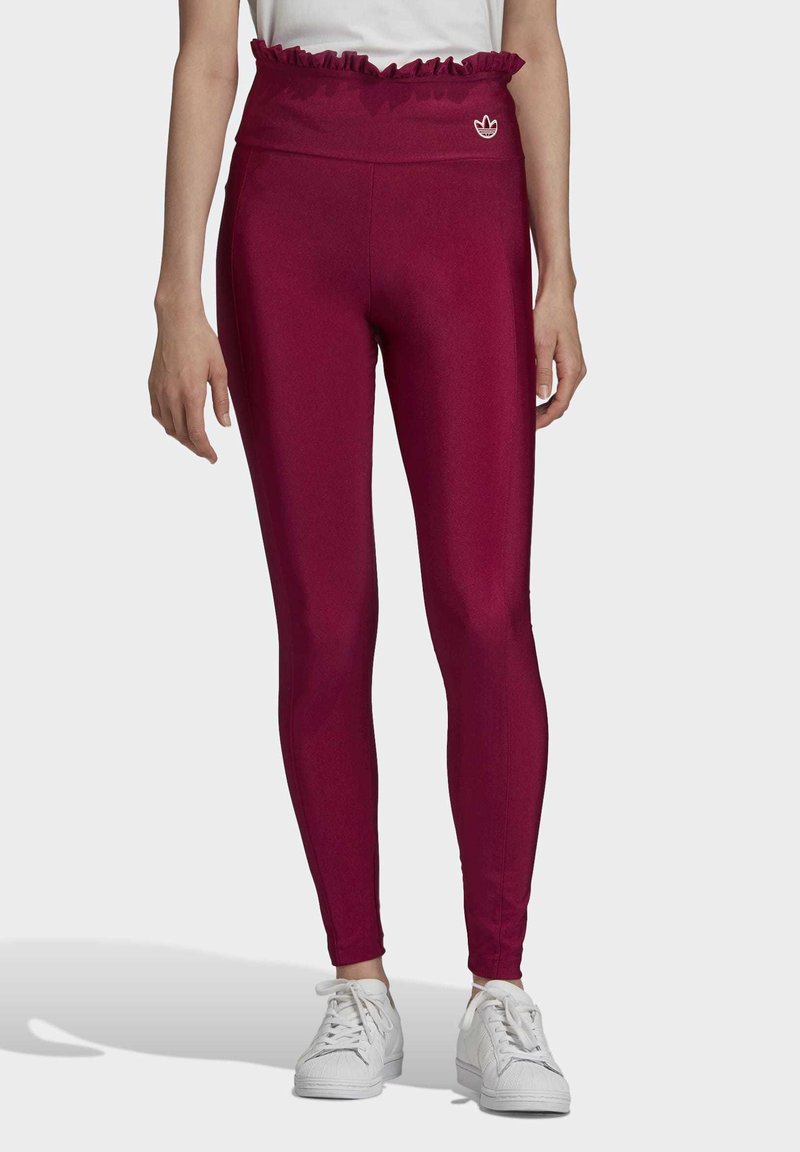 Mörkröda leggings med volangmidja, prydda med en liten vit logotyp och tillverkade av ett mjukt, elastiskt material för en figurnära passform.