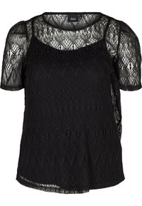 Blouse en dentelle noire avec des manches courtes transparentes, un col rond, des motifs en dentelle complexes et une coupe ample avec un ourlet festonné.