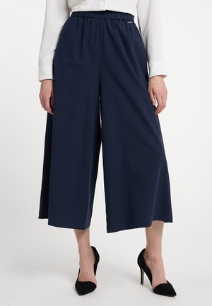 Navy wide-leg trousers with an elastic waistband, made from lightweight fabric, featuring a smooth texture and minimal design accents.