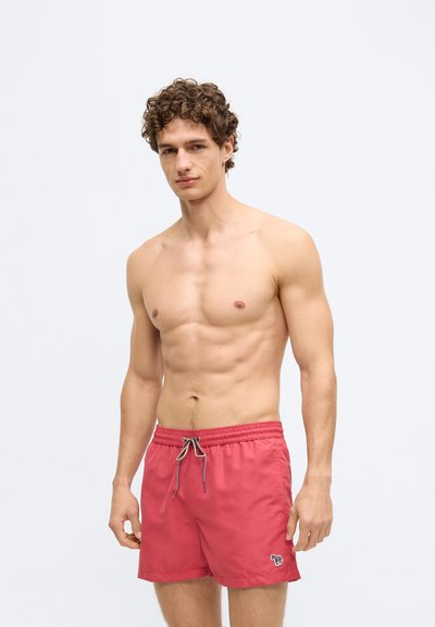 Röda badshorts med resår i midjan, dragsko och en liten logga på vänstra fållen. Mjukt, lättviktsmaterial.