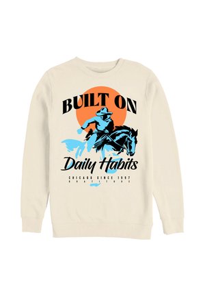 Sweat-shirt avec un graphisme d'un cow-boy bleu chevauchant un cheval devant un soleil orange, texte « Built on Daily Habits » et « Chicago Since 1997. »