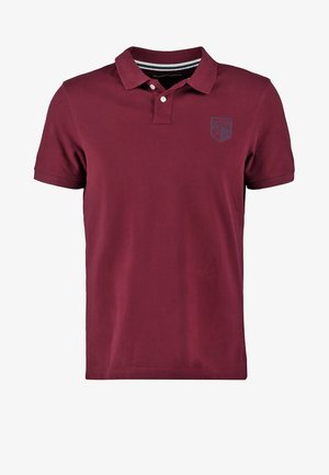 Bordeaux polo shirt van katoen, met korte mouwen, een knoopsluiting met twee knopen en een klein logopatch op de linkerborst. Gestreepte kraagvoering.