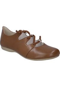 Brown leather shoe featuring a rounded toe, cut-out design, and lace-up front with matching laces. Soft inner lining and low sole.