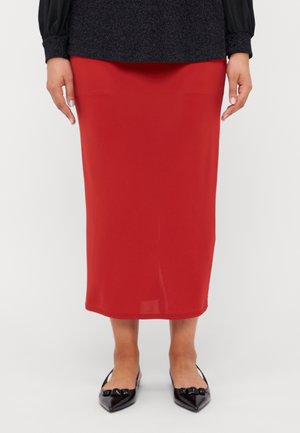 Red mid-length skirt with a smooth texture, featuring a straight design. Worn with black pointed flats that have bow accents.