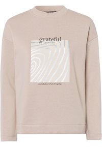 Lichtbeige sweatshirt met een ronde hals, met een zilver abstract ontwerp en tekst: "dankbaar voor waar ik ben, enthousiast over waar ik naartoe ga."