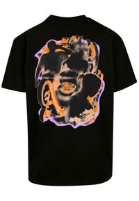 Black cotton t-shirt featuring a vibrant orange and purple graphic design of silhouetted figures and abstract shapes on the back.