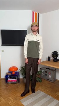 Πουκάμισο με μακριά μανίκια, κρεμ πάνω μέρος και ελιά κάτω μισό, συνδυασμένο με καφέ παντελόνι και σκούρες παπούτσια. Διαθέτει λογότυπο στο στήθος.