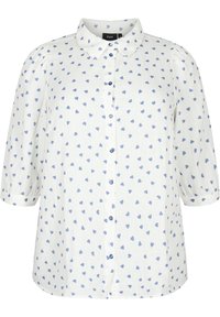 White button-up shirt with blue heart pattern, short puffed sleeves, and blue buttons. Fabric appears lightweight with a textured finish.