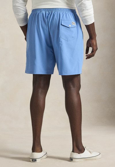 Light blue swim shorts with an elastic waistband and a back pocket. Features a smooth texture and a straight cut, suitable for casual wear.