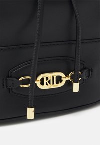 Black leather handbag with a smooth texture, featuring a gold-tone clasp with "RL" initials and drawstring closure.