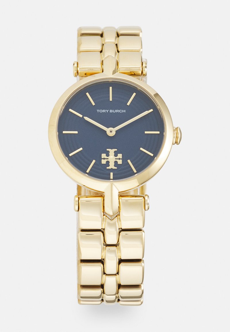 Reloj de metal en tono dorado con una esfera redonda azul, acentos dorados y pulsera de eslabones. Presenta una textura sutil y un logo en el centro.