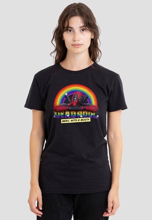 Woman wearing black t-shirt with Deadpool leaning on rainbow circle and text "Deadpool Merc with a Mouth" on a gray background.