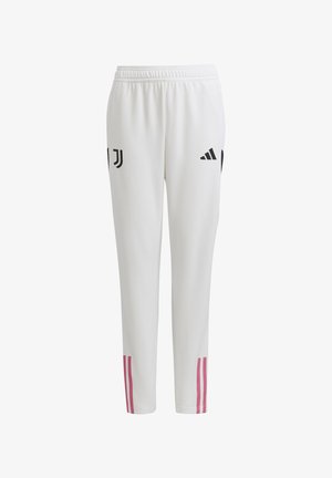 Pantalons de sport blancs avec une coupe slim, ornés de logos noirs et de deux rayures roses sur les côtés inférieurs. Fabriqués en matériau lisse et flexible.