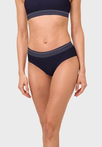 Navy bikini set featuring a textured band with white stripes. The top has a structured design; the bottoms are high-waisted for coverage.