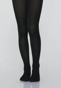 Collant neri con texture, leggermente scintillanti, dalla forma aderente e dall'aspetto liscio; senza cuciture o motivi visibili. Design senza piedi.