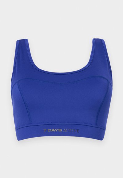 Blue activewear bra made of stretchy fabric. Features a scoop neck, wide straps, and a lower elastic band with "7 DAYS ACTIVE" printed in silver.