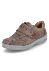 Brown leather sneaker with a Velcro strap, grey rubber sole, contrasting stitching, and subtle brown accents on the strap.