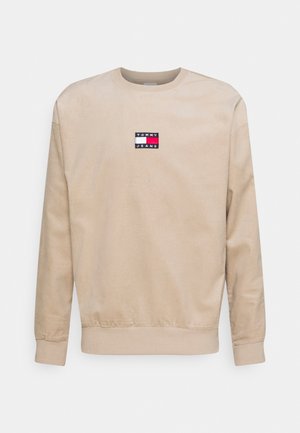 Beige langærmet crewneck sweatshirt med Tommy Jeans-logo i rød, hvid og blå centralt placeret på brystet.