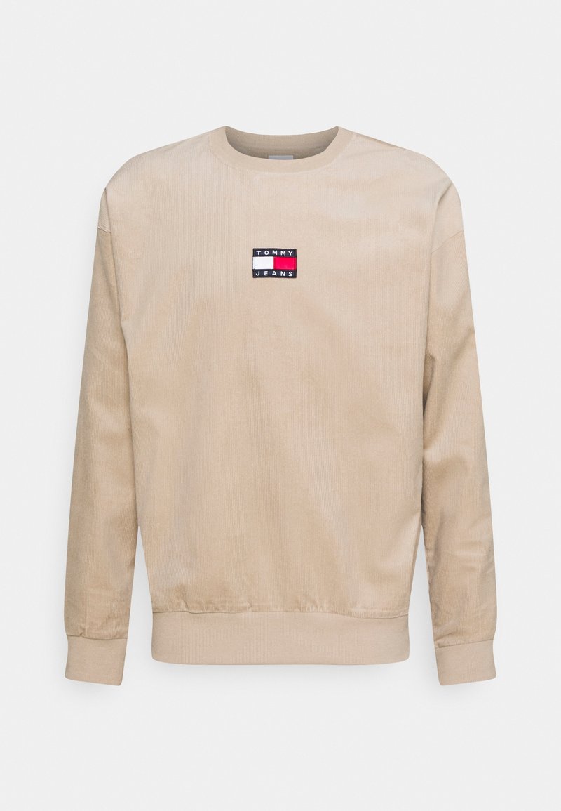 Sweat-shirt beige à manches longues et col rond avec logo Tommy Jeans en rouge, blanc et bleu centré sur la poitrine.