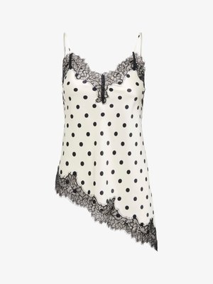Camisole en soie ivoire à pois noirs, bordure en dentelle noire le long de l'encolure et ourlet asymétrique, avec fines bretelles ajustables.