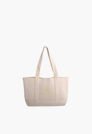 Bolso tote de tela beige con textura acanalada, dos asas largas y logo "Don Algodon" en letras doradas en la parte delantera.