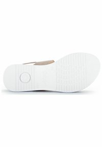 Flat shoe sole with a textured white rubber base, featuring a circular indentation and light brown suede accents.