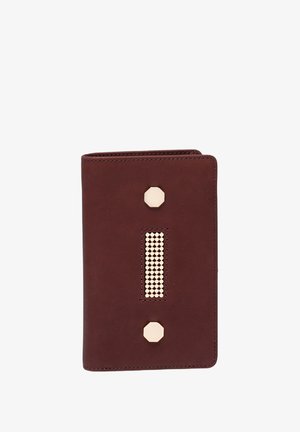 Burgundy leather wallet with a textured center strip of studs, gold-tone hexagonal hardware accents, and a sleek, rectangular design.