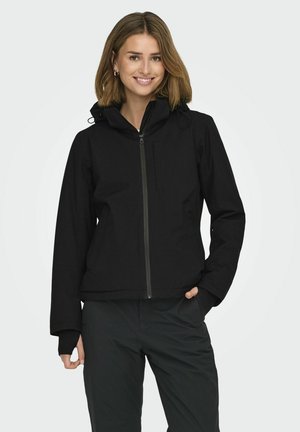 Veste à zip noir avec capuche, présentant une texture lisse, des poches avant et des poignets élastiques. Conçue pour une silhouette ajustée.