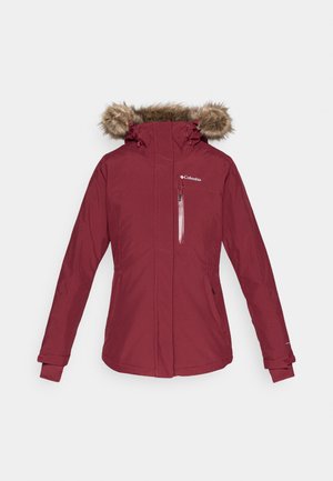 Burgunderfarbene wasserdichte Jacke mit einer Kapuze aus Kunstfell, einem Reißverschluss-Brusttasche und elastischen Bündchen. Hat ein tailliertes Design mit seitlichen Taschen.